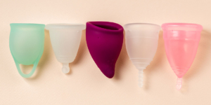 Five menstrual cups in a line.
