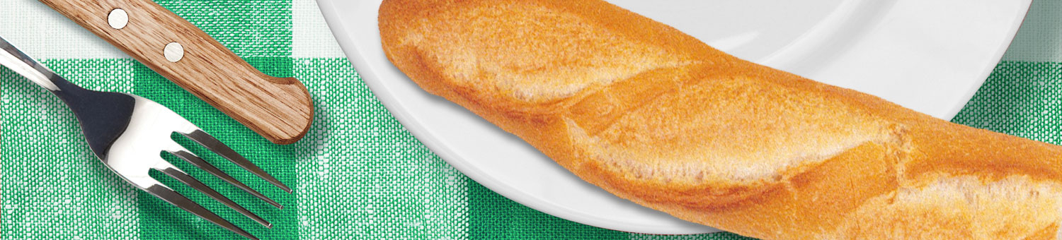White dinner plate with baguette, with knife and fork on a green checked table cloth